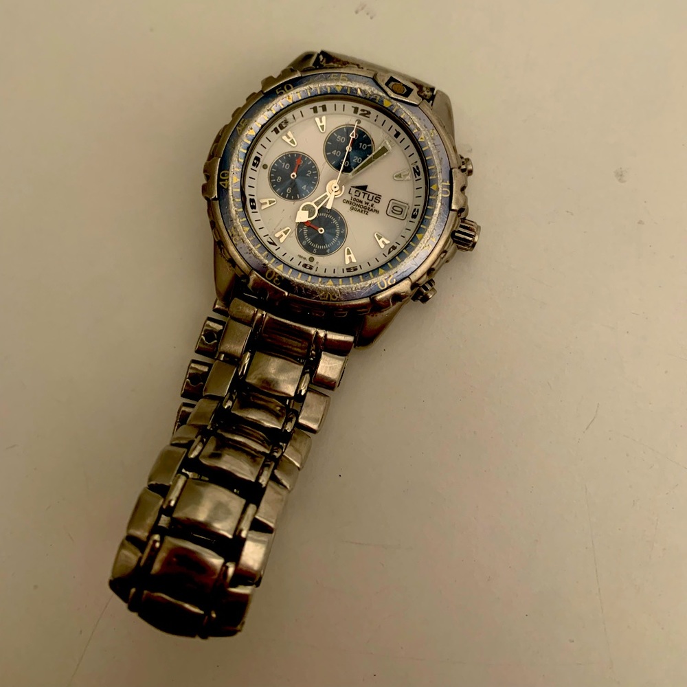 LOTUS WATCH:  water resistant (up to 100m) quartz watch. Metal watch strap